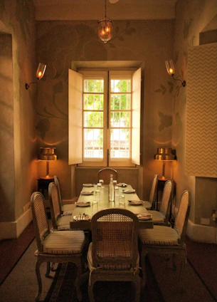 Elegant dining room set with wooden table and chairs under soft lighting