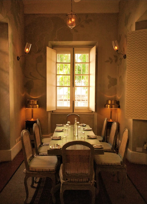 Elegant dining room setup featuring a custom wooden table and chairs in natural light