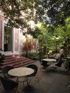 A serene outdoor seating area surrounded by lush greenery, perfect for relaxation after temple visits.