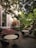 Guests enjoying a peaceful garden seating area surrounded by lush greenery.