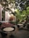 Guests enjoying a peaceful garden seating area surrounded by lush greenery.