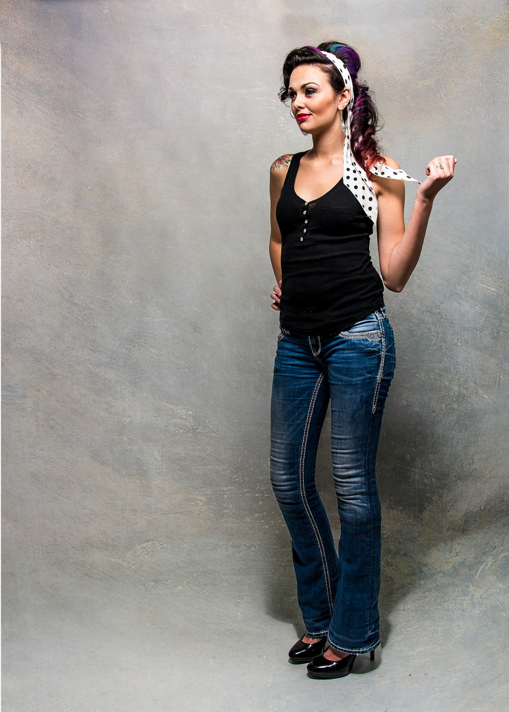 woman in black tank top and blue denim jeans