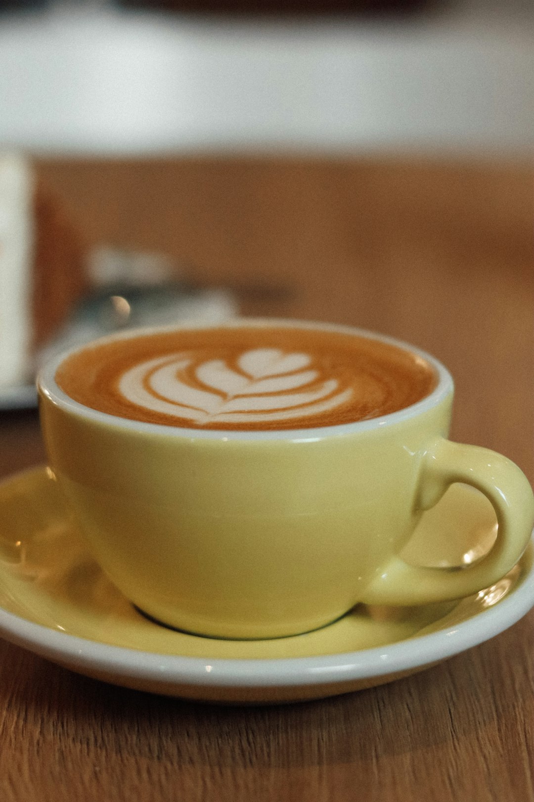 yellow ceramic cup with saucer