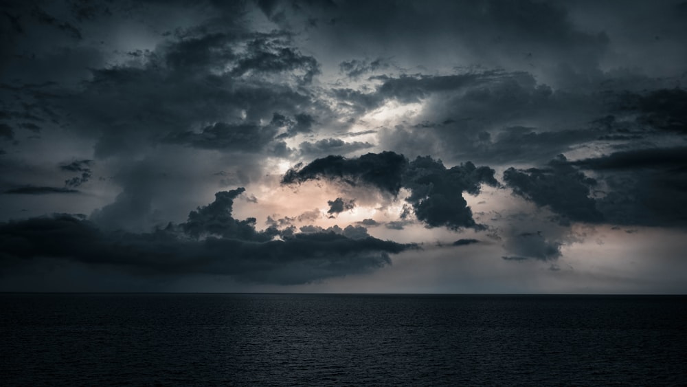 body of water under cloudy sky during daytime