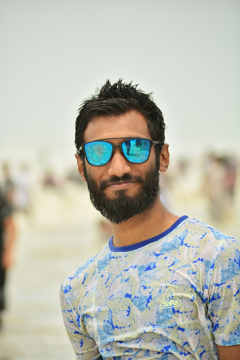 man in white and blue crew neck shirt wearing blue sunglasses