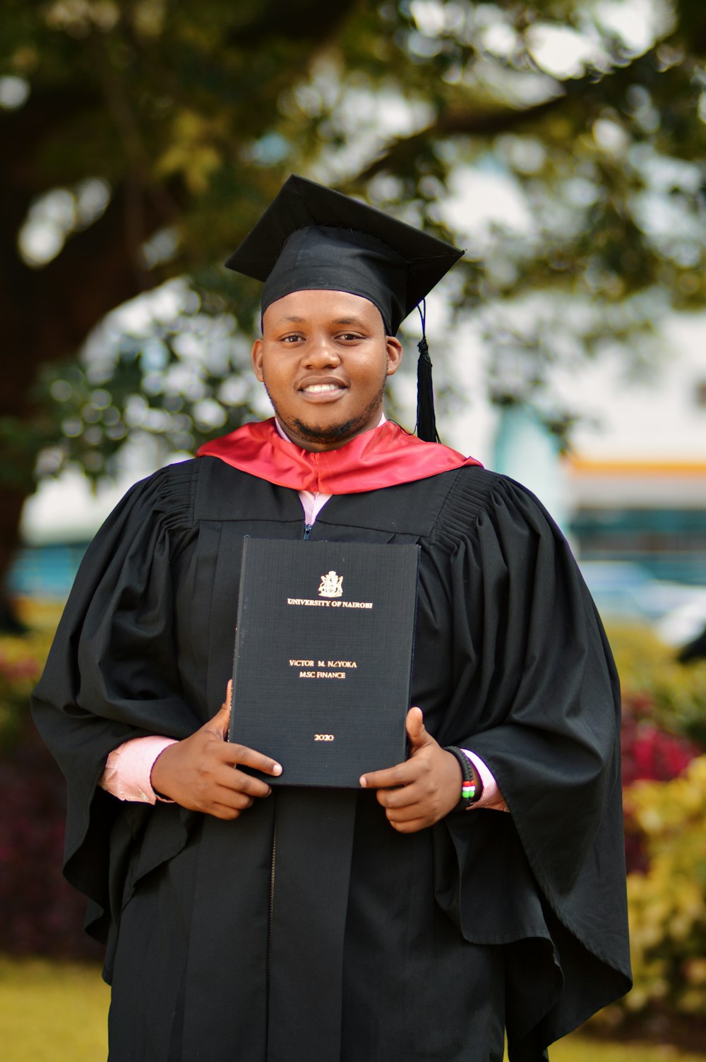 man in academic dress and academic hat