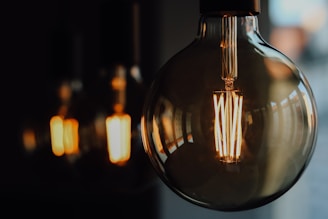 Close-up of a stylish table lamp with a glowing filament bulb enhancing ambiance.