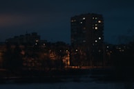 Nighttime photo of a residential project illuminated with warm ambient lighting.