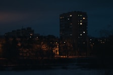 Nighttime exterior shot of 57 and co building with warm lights glowing.