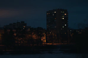 Evening exterior of a residential project illuminated with warm lighting