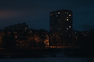 Evening shot of a residential project illuminated with warm outdoor lighting