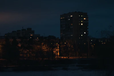 Night view of a premium real estate development illuminated with warm lighting.
