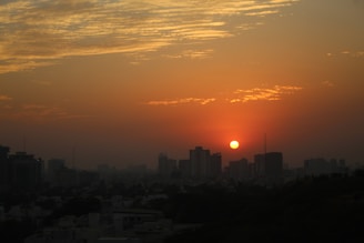 A vibrant sunset over a bustling African city skyline.