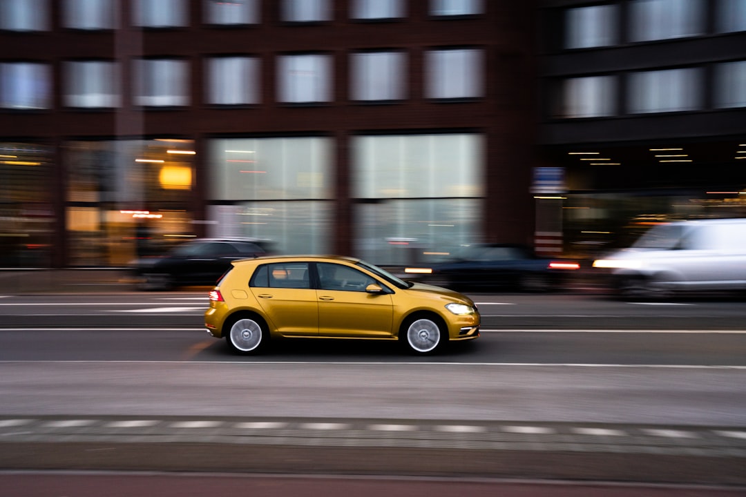 yellow sedan on road during night time