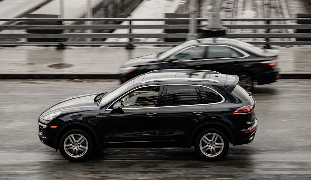 black sedan on road during daytime