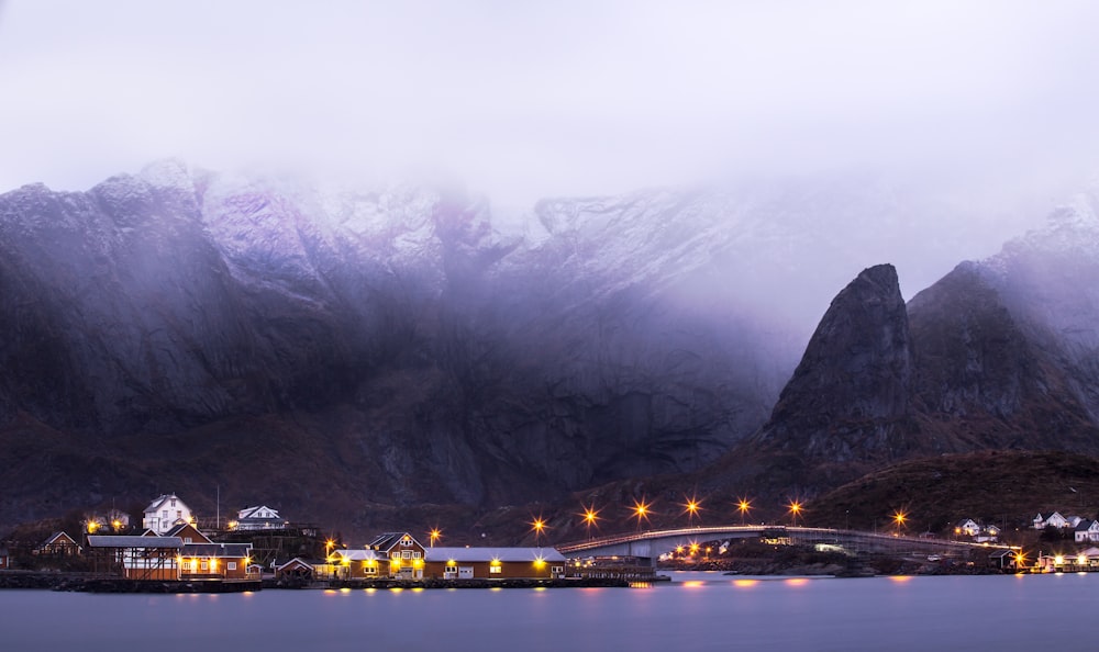 city lights on mountain near body of water during night time