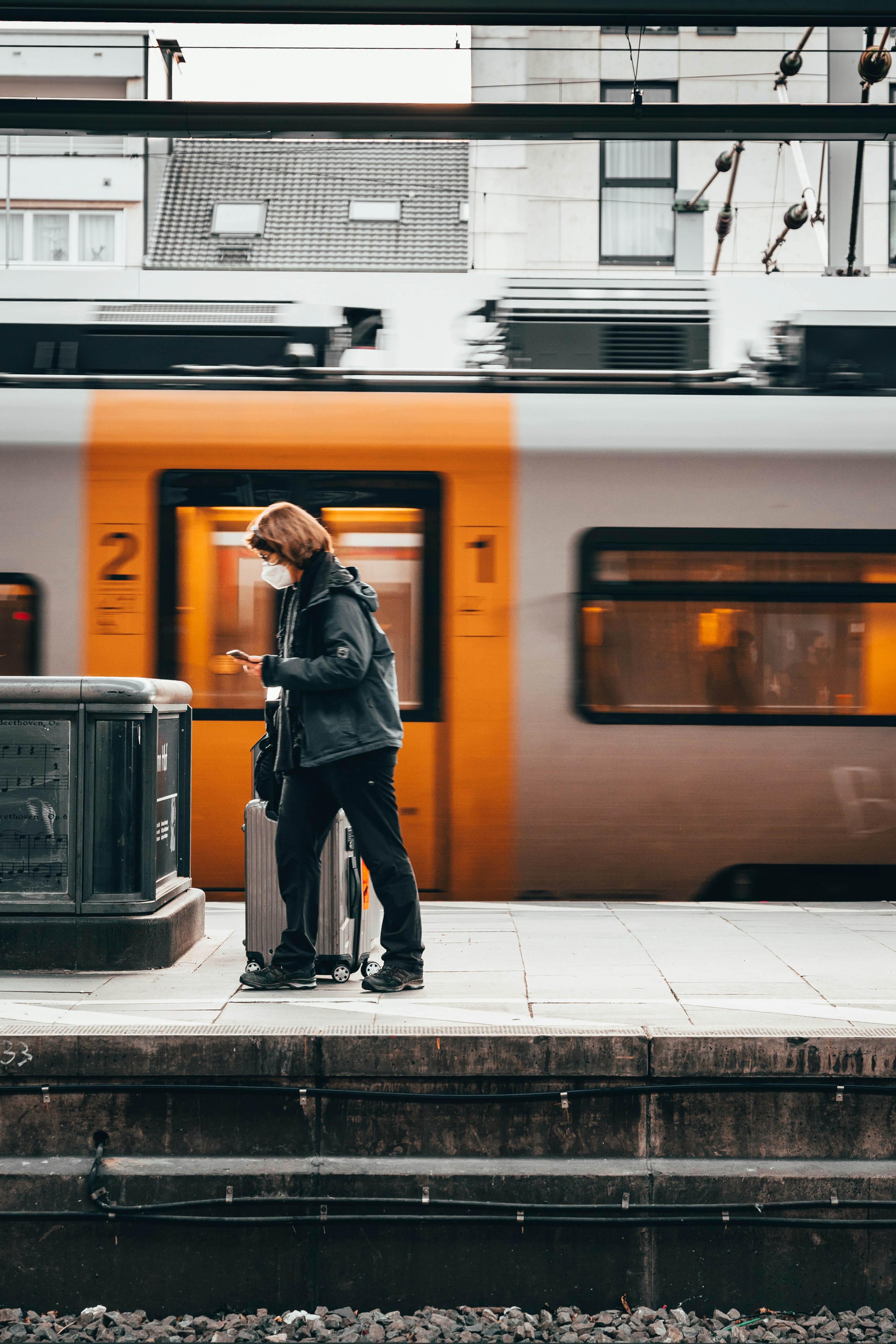 traveller on platform with train behind