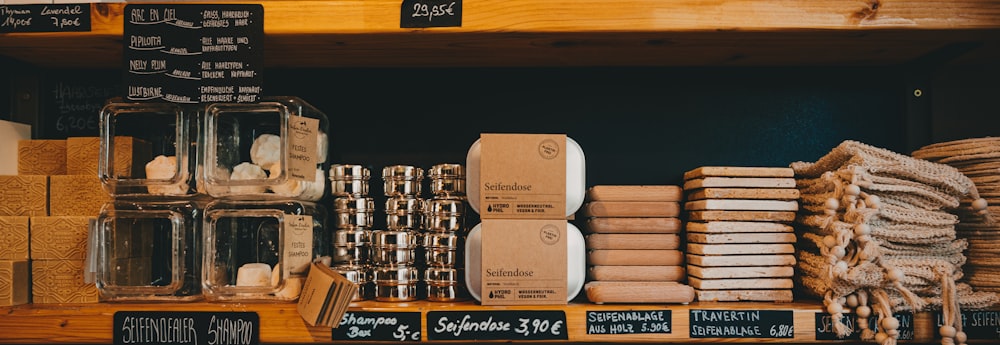 brown cardboard boxes on brown wooden shelf