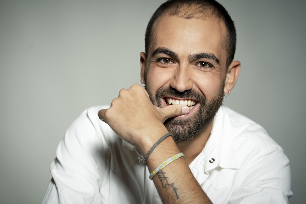 man in white dress shirt wearing green bracelet