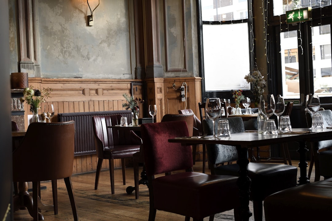 brown wooden table and chairs, Cozy Pub in London.
