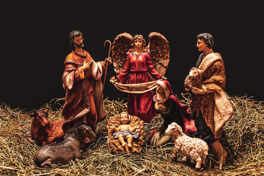 3 men sitting on ground,<p></figure>Nativity scene on dark background