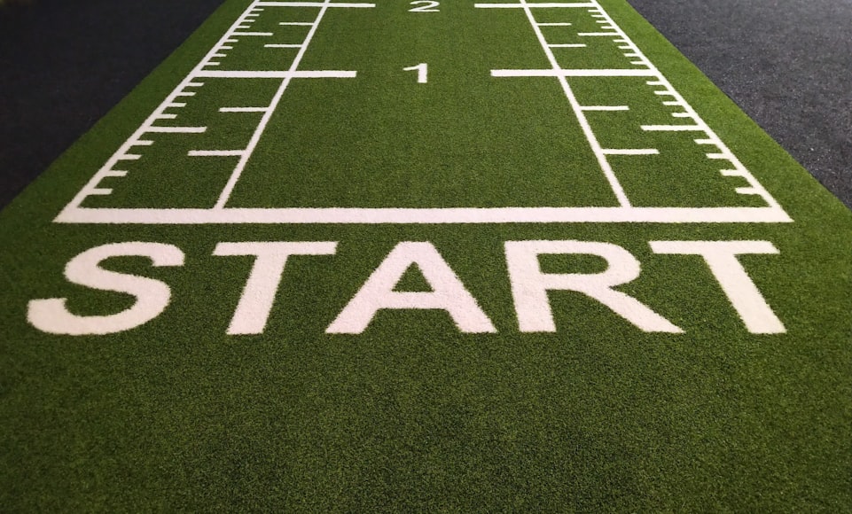 Image of a sports field with the word 'START' painted on it