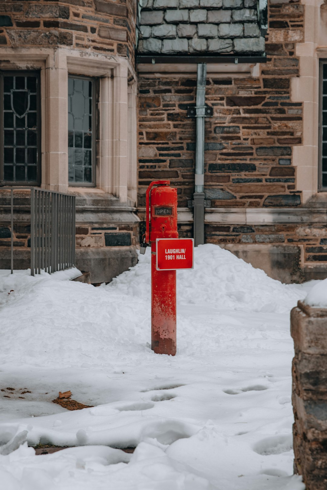 red and white metal post on snow covered ground