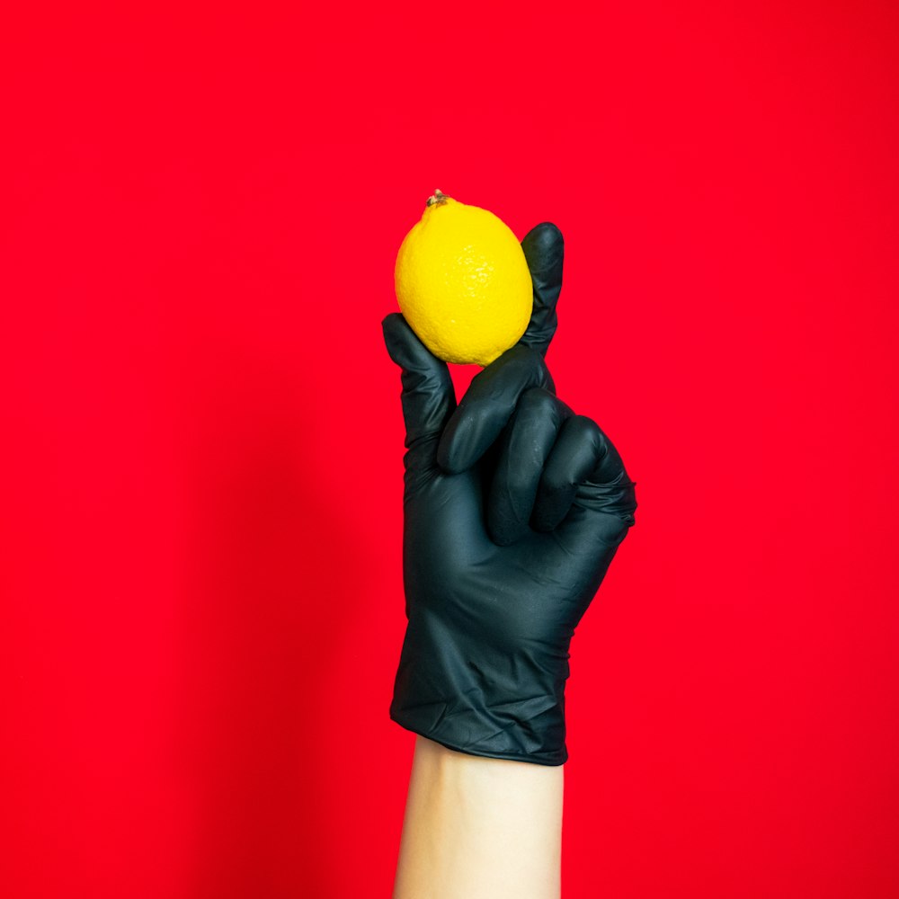 person holding yellow citrus fruit