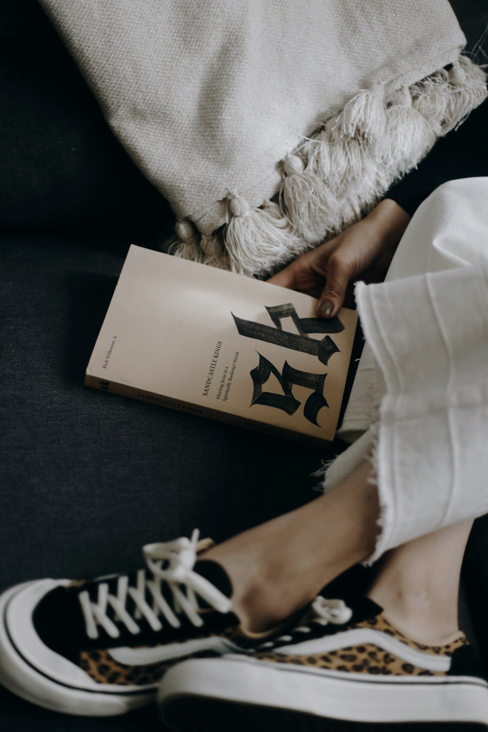 person in white long sleeve shirt holding white book