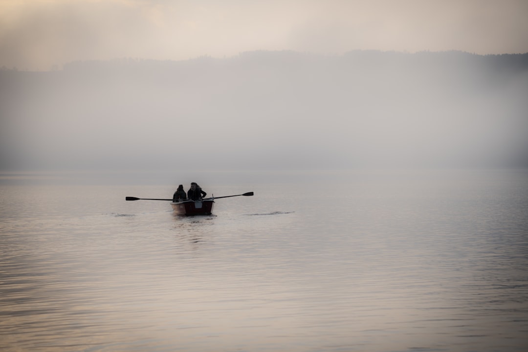 man riding on boat on sea during daytime