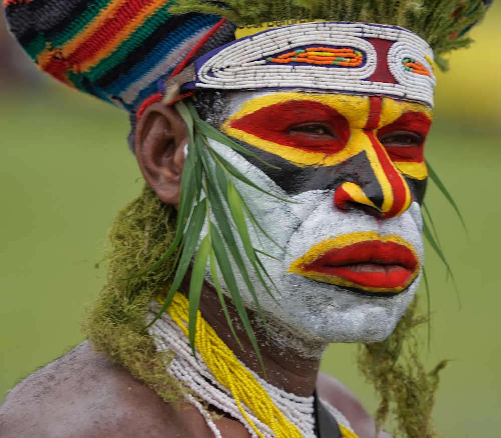 person with multi color face paint