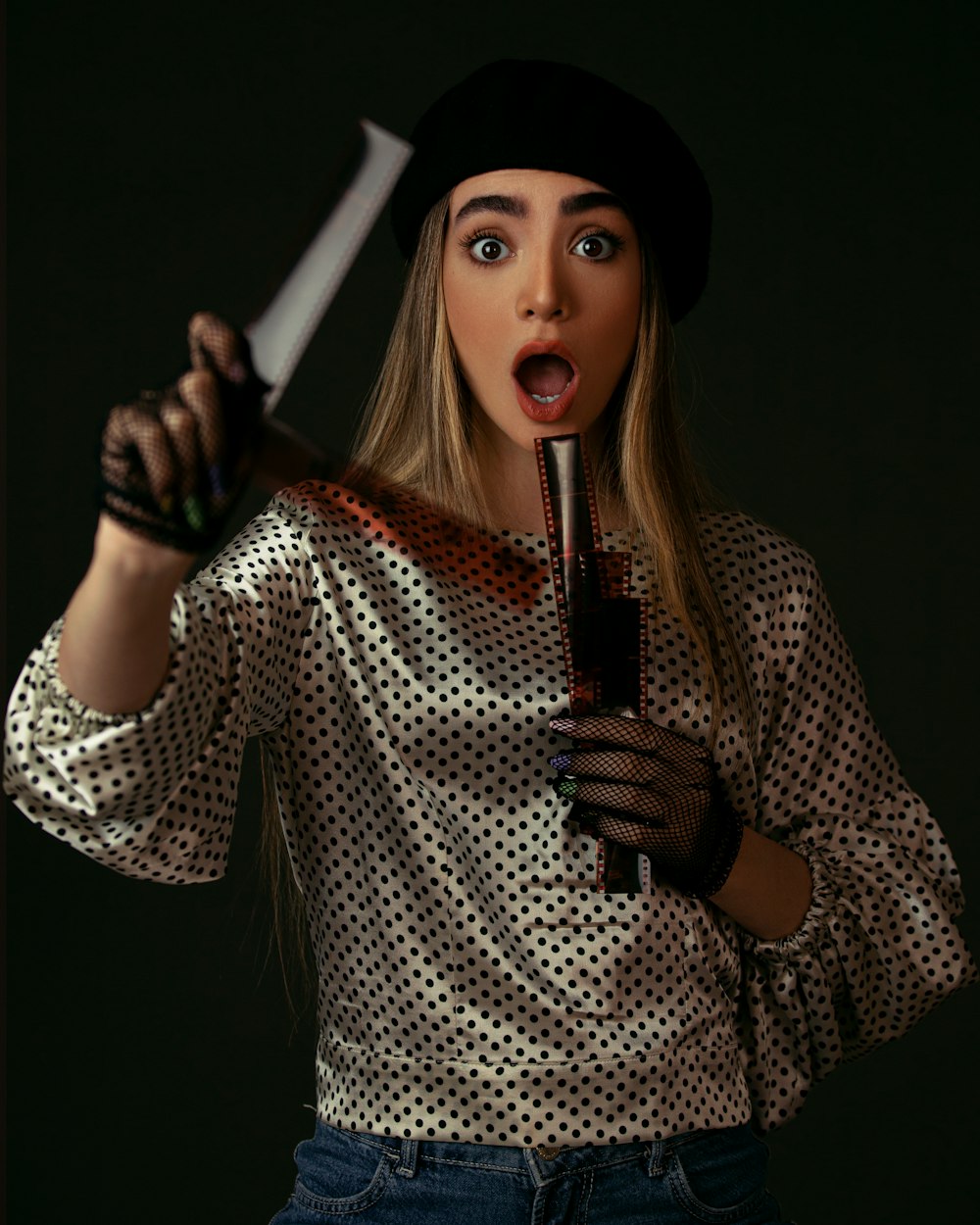 woman in white and black polka dot long sleeve shirt holding white stick