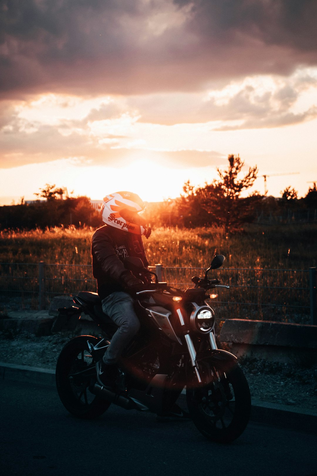 man in black jacket riding motorcycle during sunset