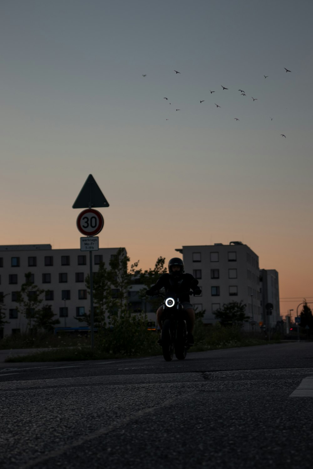 man in black jacket riding bicycle on road during daytime