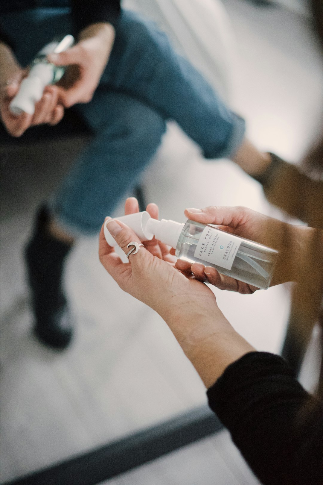 person holding white plastic bottle