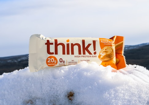 yellow and white plastic pack on white snow