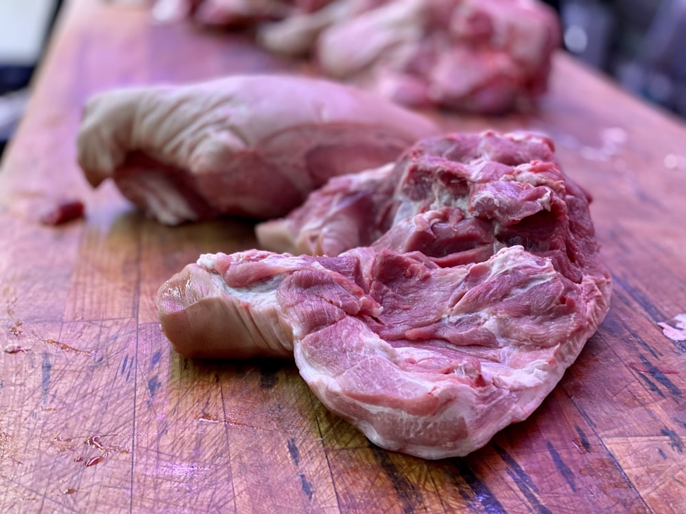 raw meat on brown wooden table