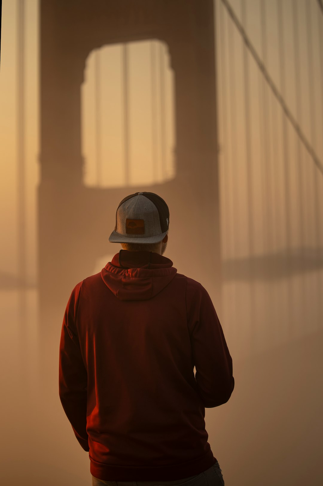 man in red hoodie wearing black helmet