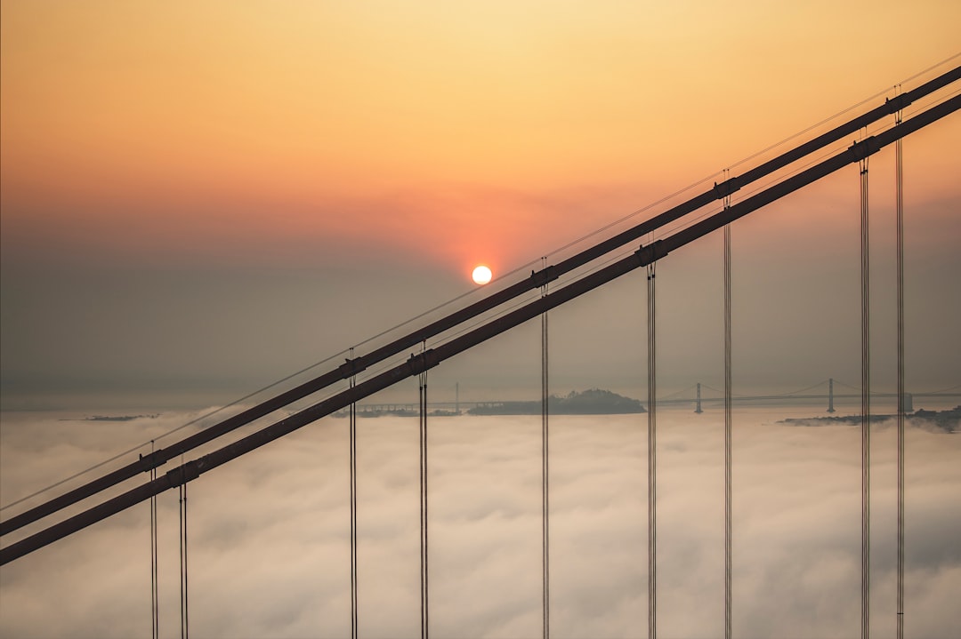 black metal bridge under blue sky during sunset