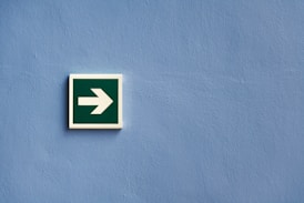 white and green arrow sign