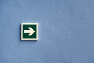 white and green arrow sign