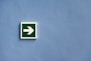 white and green arrow sign