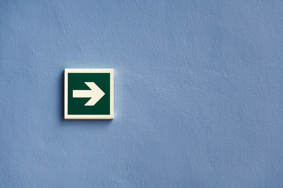 White and green arrow sign