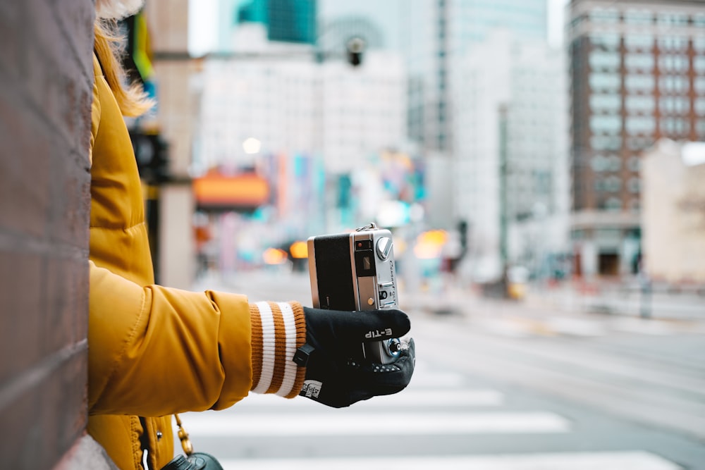 person holding black dslr camera