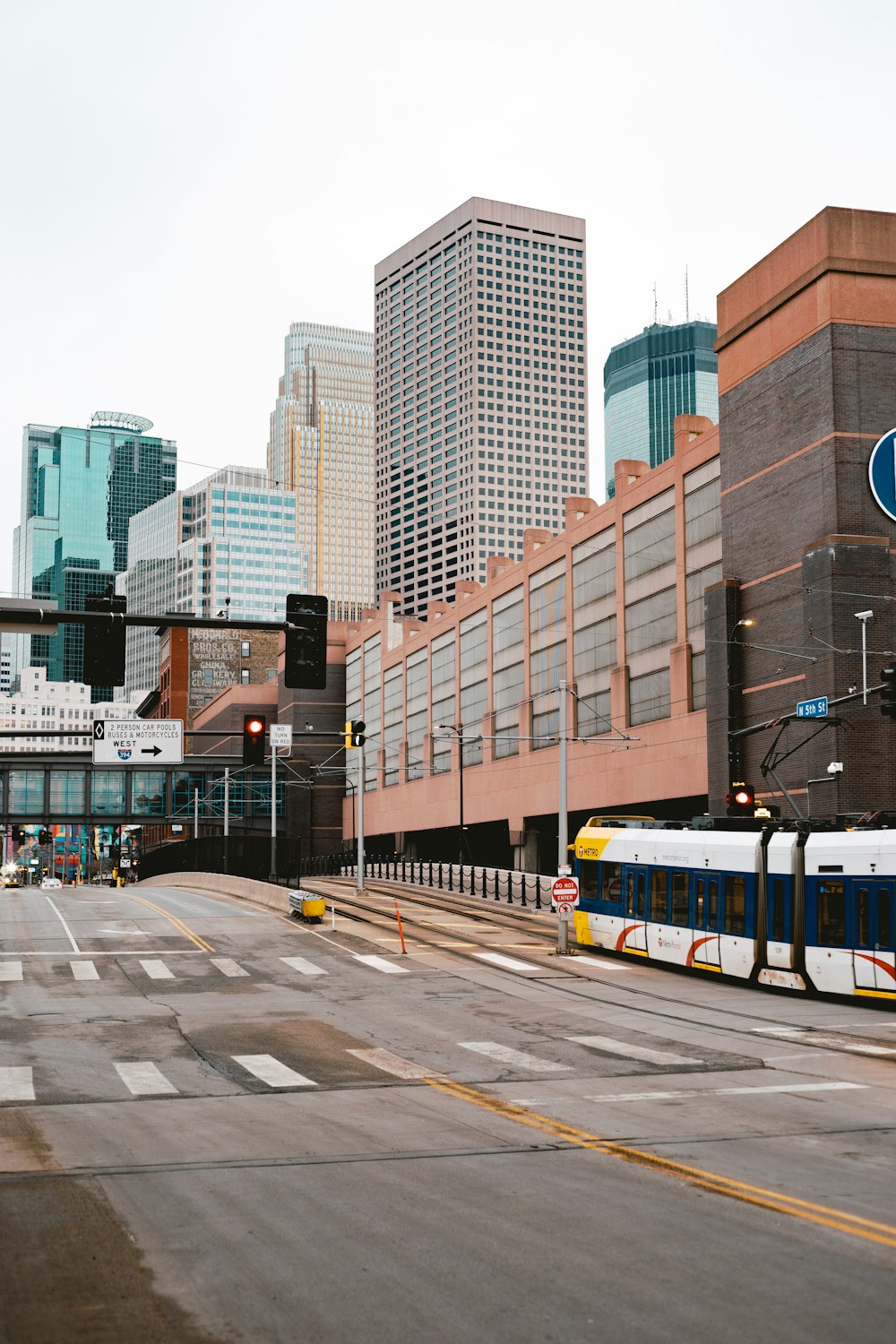 white and yellow train on road near brown concrete building during daytime