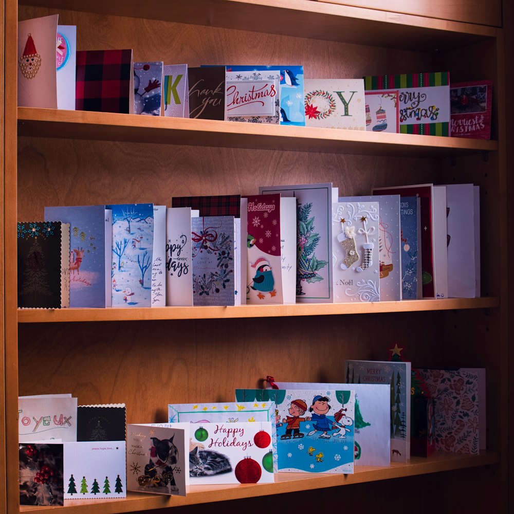 white and blue book on brown wooden shelf