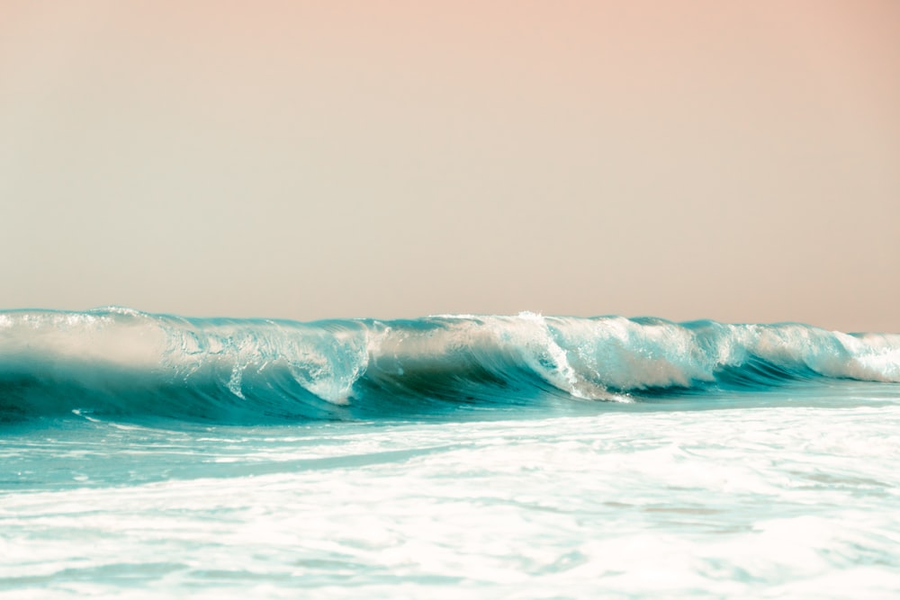 ocean waves crashing on shore during daytime