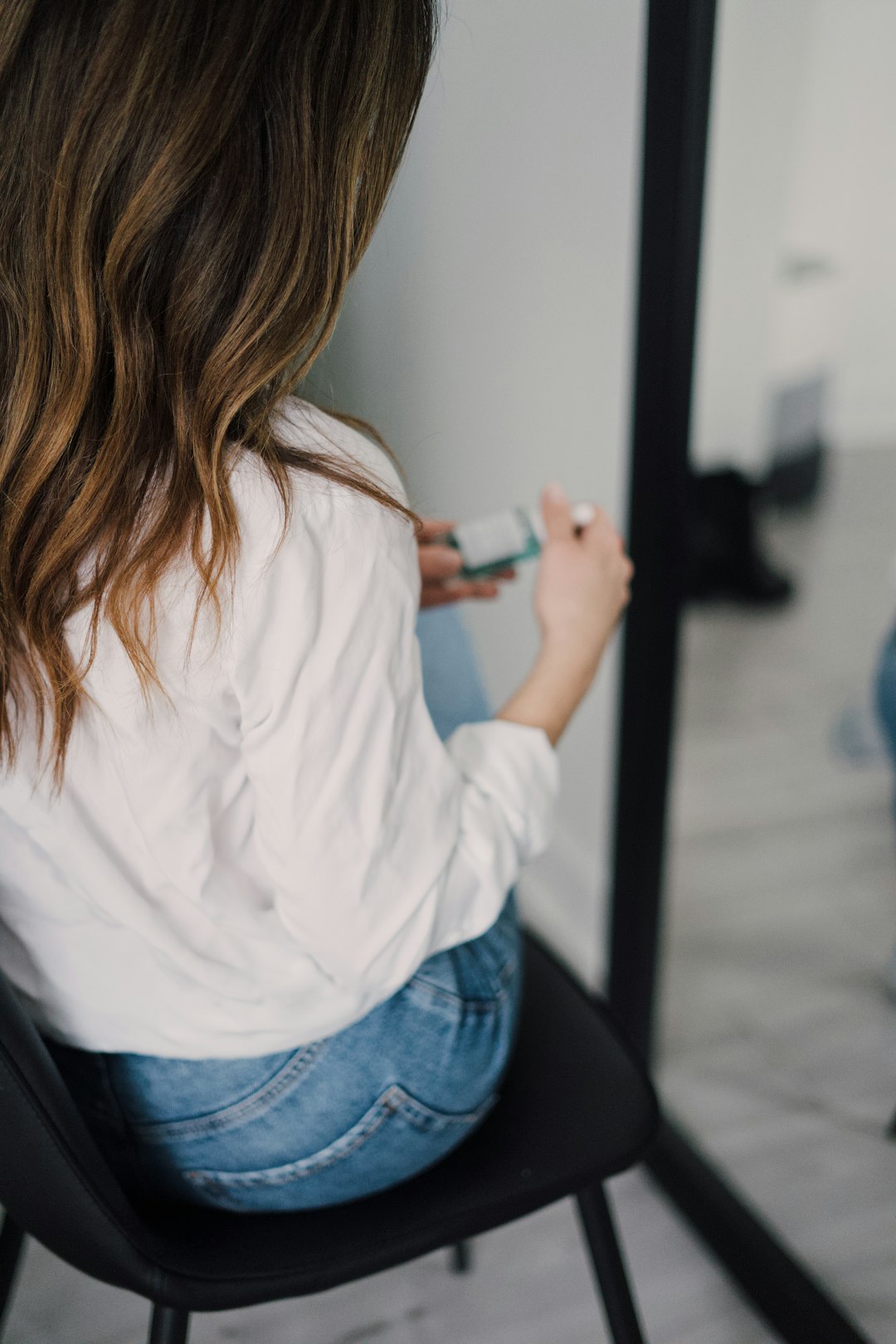 woman in white long sleeve shirt and blue denim jeans