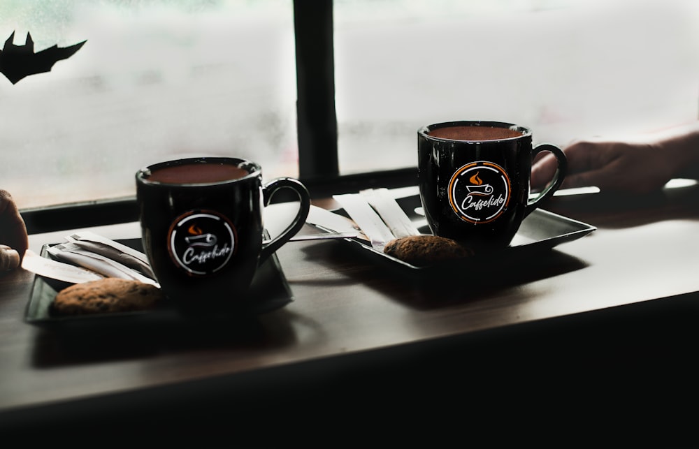 black and white ceramic mug on brown wooden table