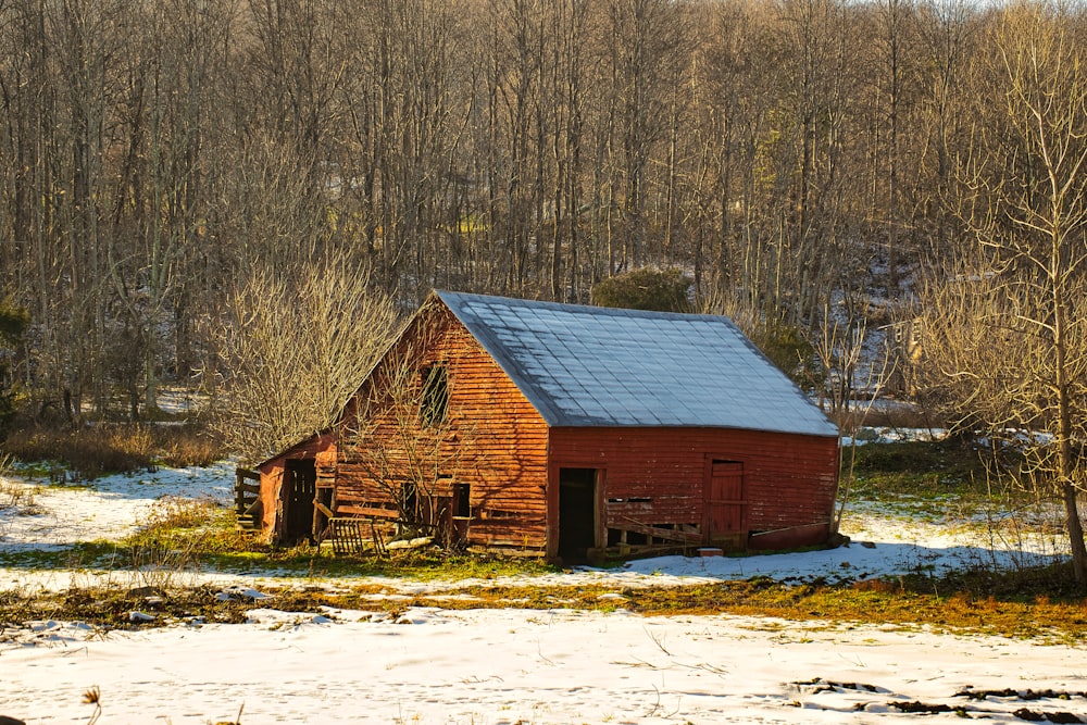 brown wooden house on snow covered ground